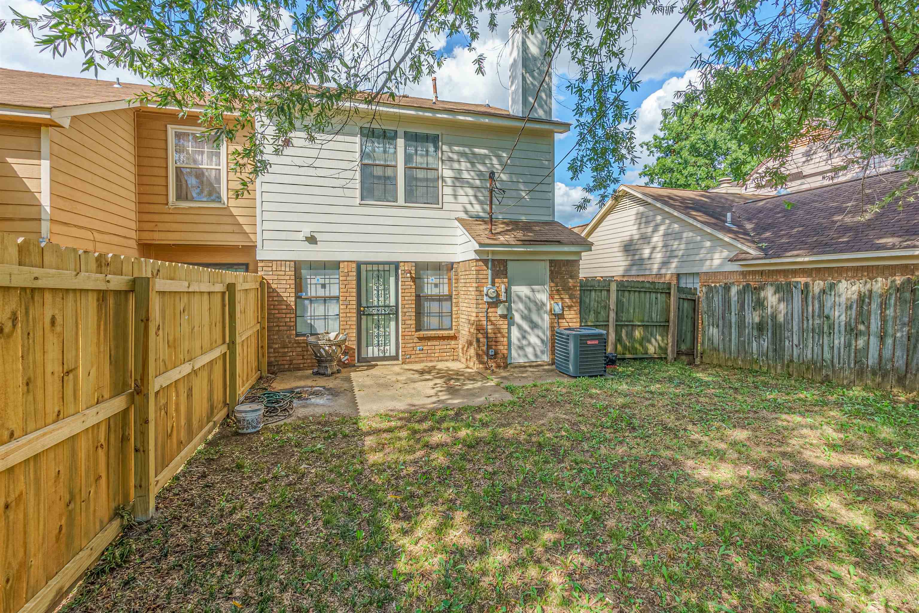 5891 Ridgehill Drive Memphis, TN 38141 - Photo 12 of 13 Rear view of house with a lawn, cooling unit, and a patio area