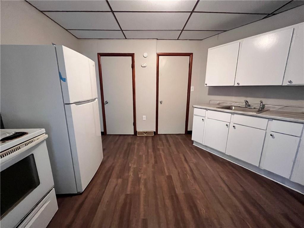 507 Harmony Avenue, Unit 1R Rochester, PA 15074 - Photo 3 of 18 a kitchen with white cabinets and white appliances