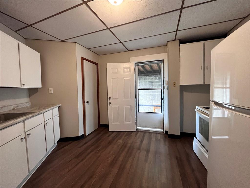 507 Harmony Avenue, Unit 1R Rochester, PA 15074 - Photo 5 of 18 a kitchen with granite countertop wooden floors and white stainless steel appliances