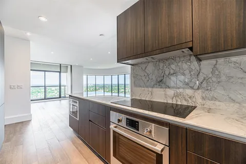 a view of a kitchen with a sink and wooden floor