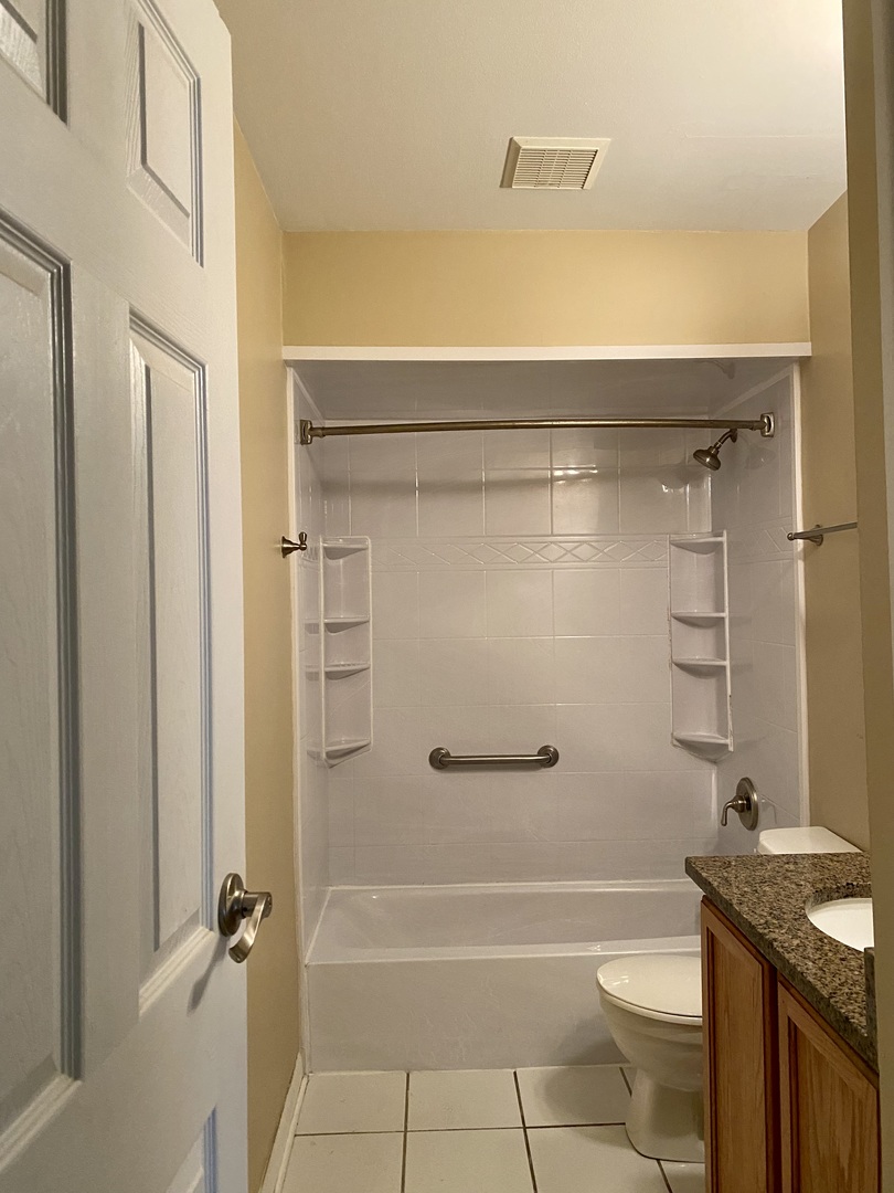 19398 Wolf Road, Unit 3 Mokena, IL 60448 - Photo 6 of 7 a bathroom with a granite countertop bathtub shower sink vanity and toilet
