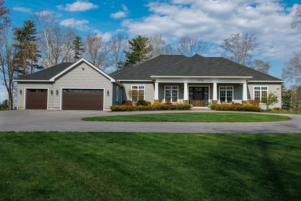 1776 Old Turnpike Road Oakham, MA 01068 - Photo 2 of 42 a front view of a house with a garden and trees