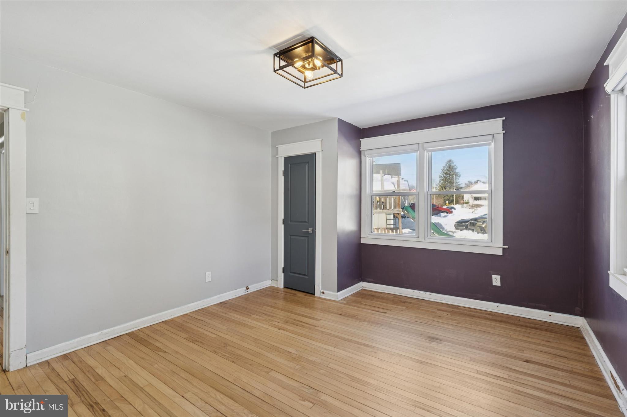 6 Cedar Road Wallingford, PA 19086 - Photo 20 of 36 a view of an empty room with wooden floor and window