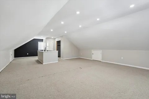 a view of a kitchen with a sink and a refrigerator