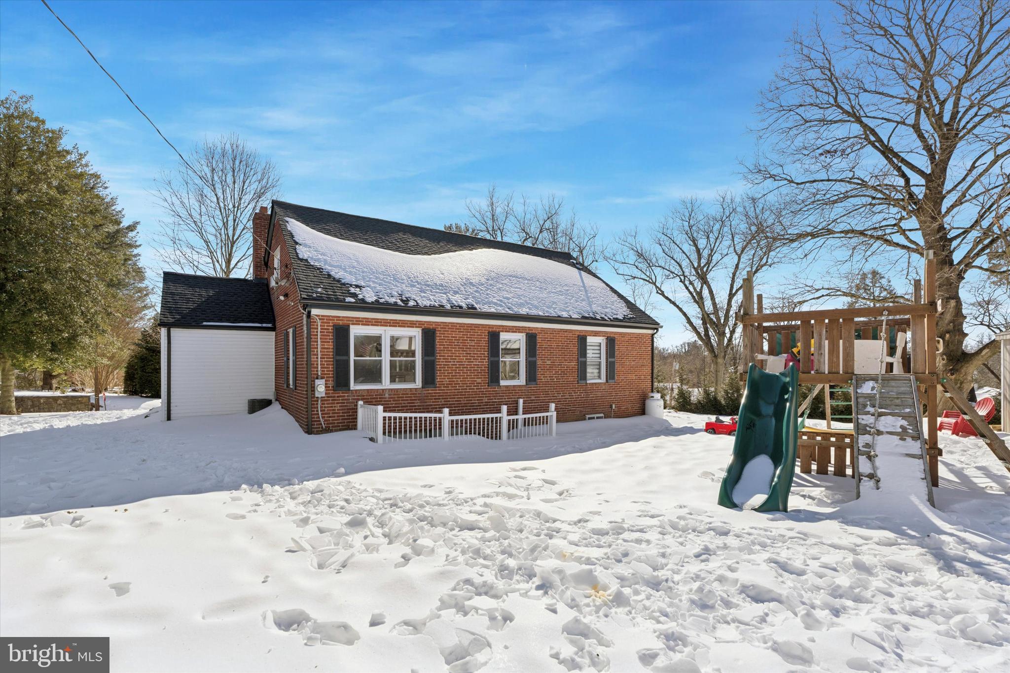 6 Cedar Road Wallingford, PA 19086 - Photo 35 of 36 a front view of a house with a yard covered in snow