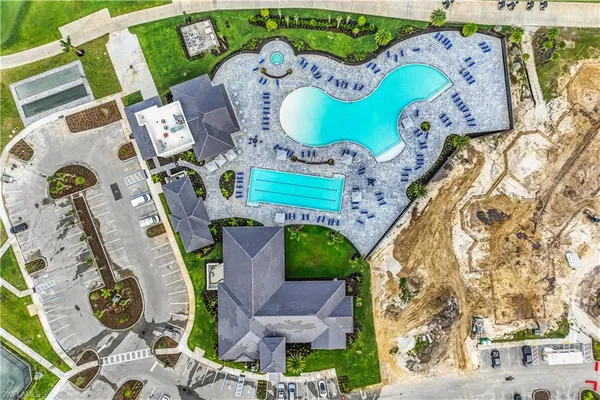 an aerial view of a house with swimming pool garden view and lake view