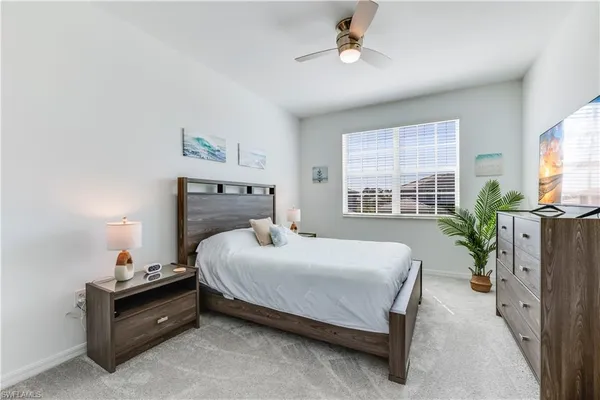 a bedroom with a bed and a potted plant