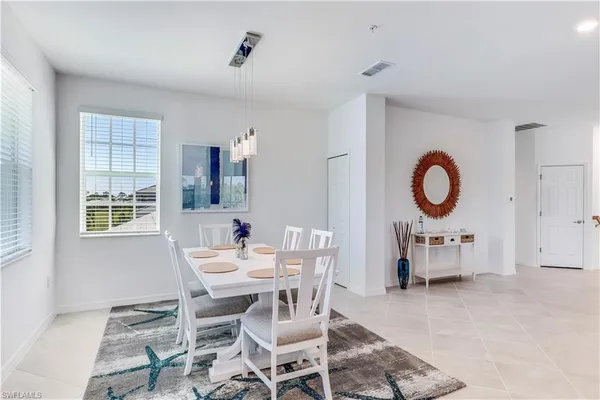 a view of a dining room with furniture and window