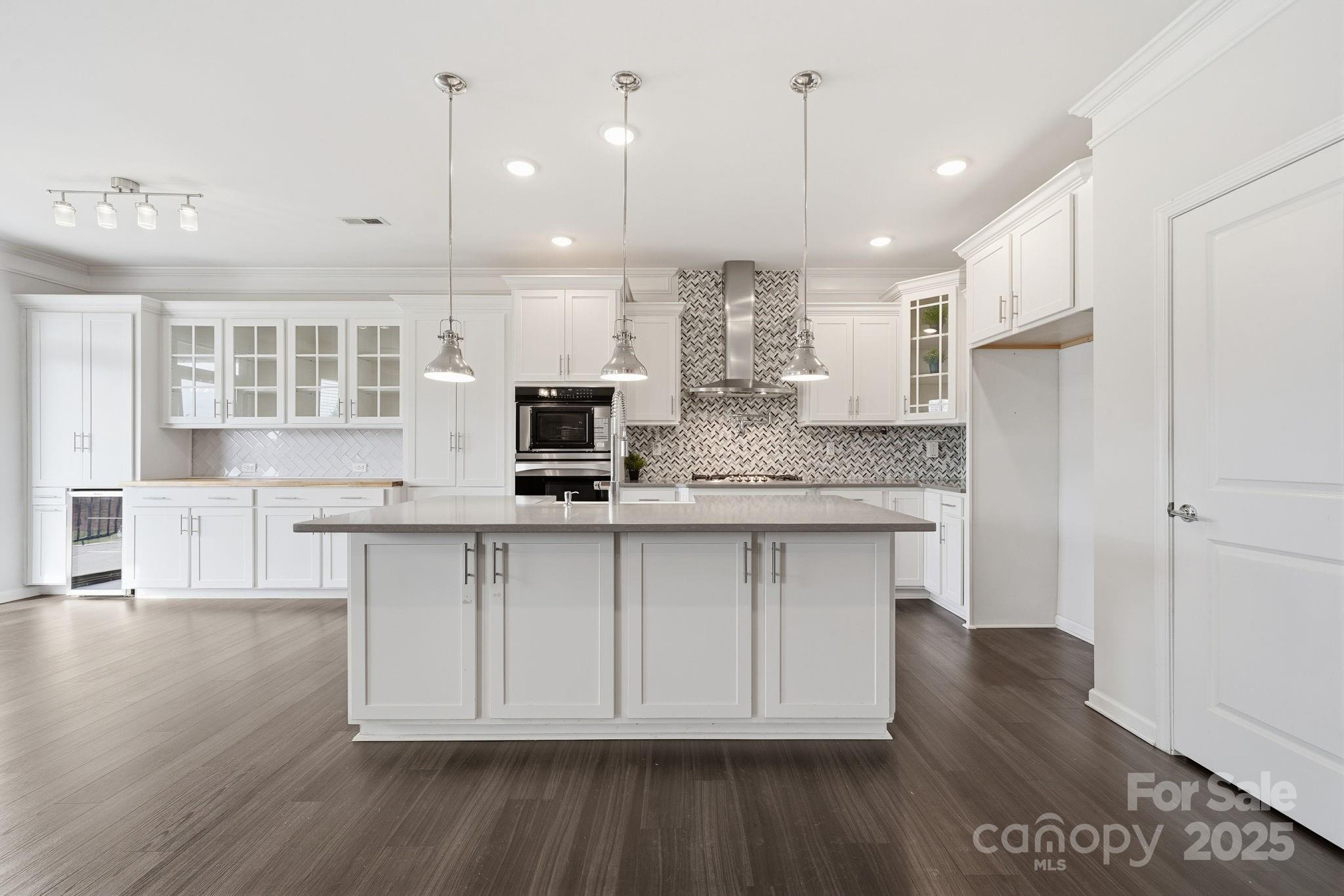 2612 Keady Mill Loop Kannapolis, NC 28081 - Photo 11 of 48 a large kitchen with stainless steel appliances granite countertop a stove a sink and a refrigerator