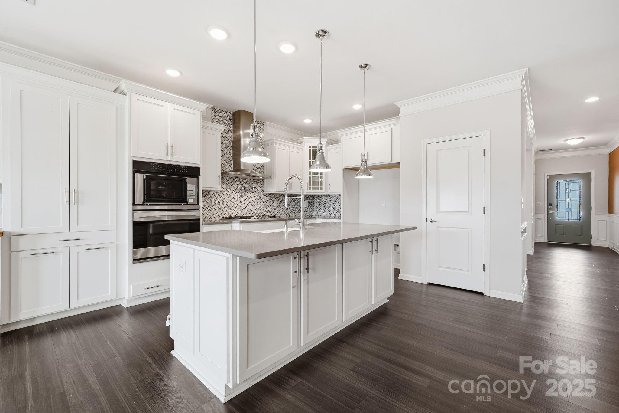 2612 Keady Mill Loop Kannapolis, NC 28081 - Photo 12 of 48 a kitchen with stainless steel appliances granite countertop a sink a stove a refrigerator and a microwave