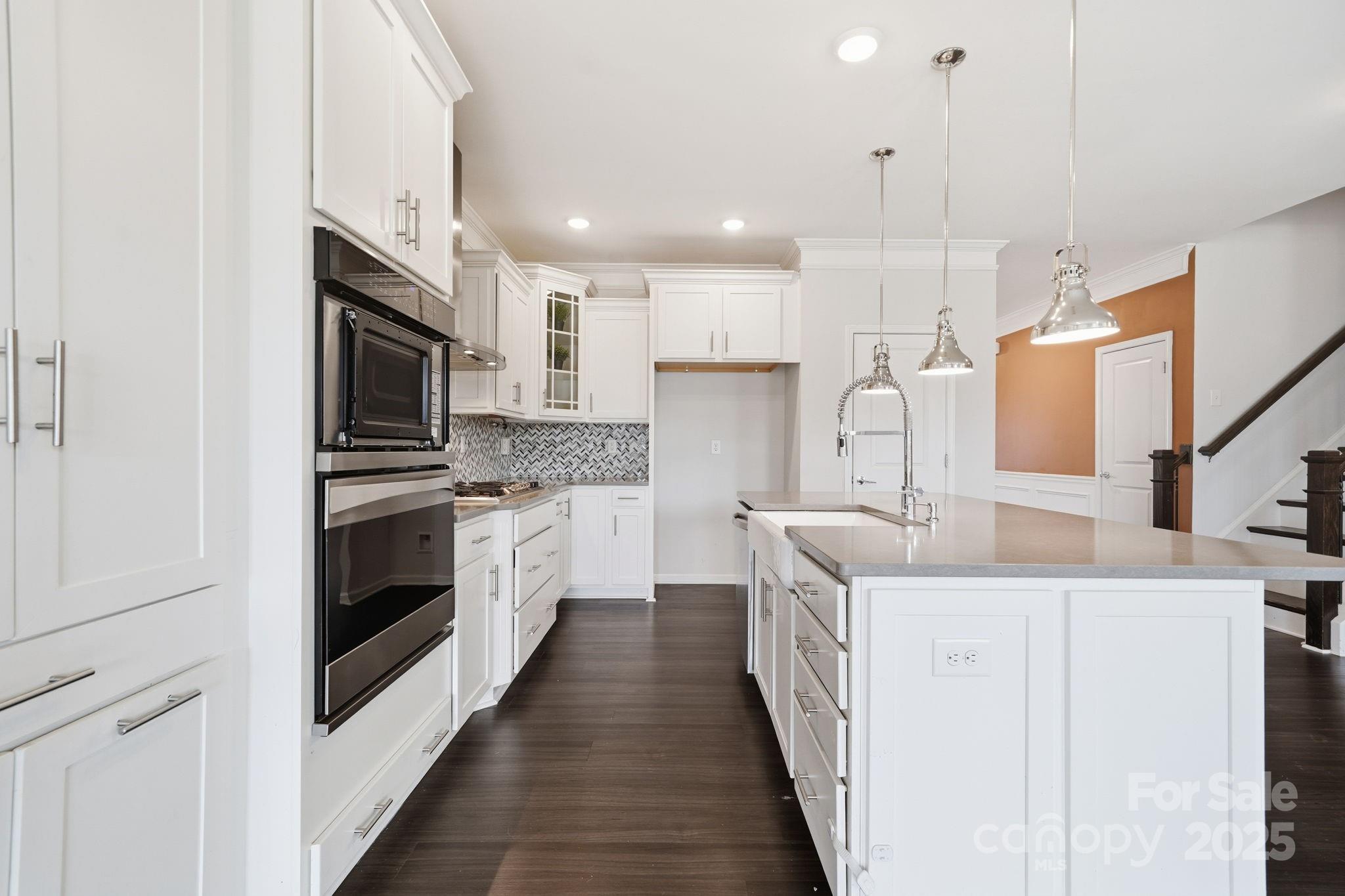 2612 Keady Mill Loop Kannapolis, NC 28081 - Photo 14 of 48 a kitchen with stainless steel appliances sink stove microwave and cabinets