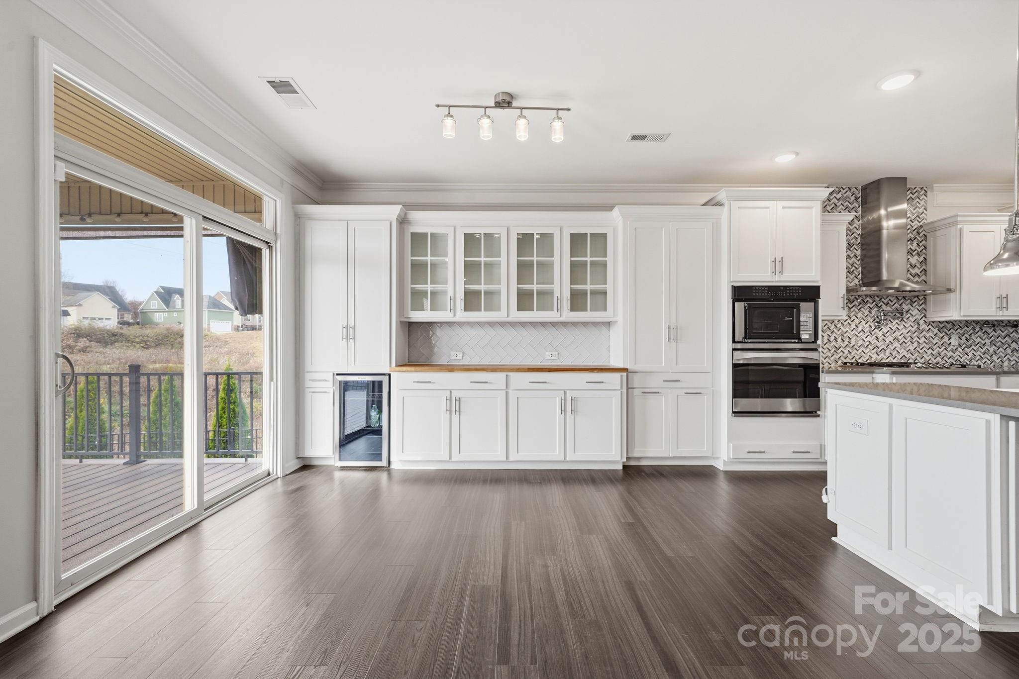 2612 Keady Mill Loop Kannapolis, NC 28081 - Photo 15 of 48 a view of a kitchen with dishwasher a refrigerator and wooden cabinets