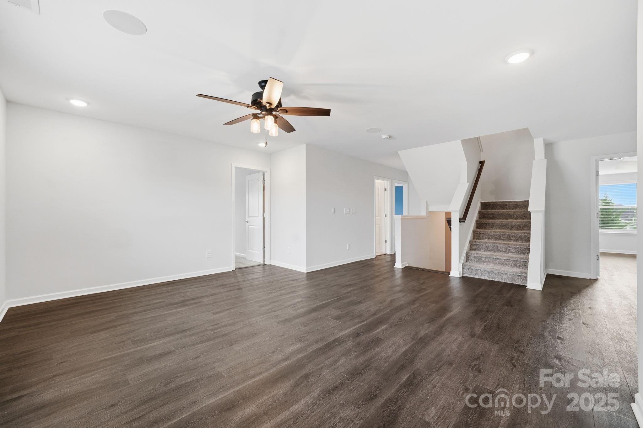 2612 Keady Mill Loop Kannapolis, NC 28081 - Photo 21 of 48 a view of an empty room with wooden floor and stairs