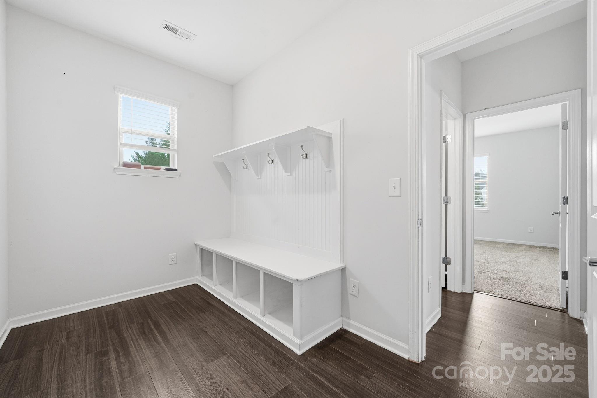 2612 Keady Mill Loop Kannapolis, NC 28081 - Photo 40 of 48 a view of an empty room with wooden floor and a bathroom
