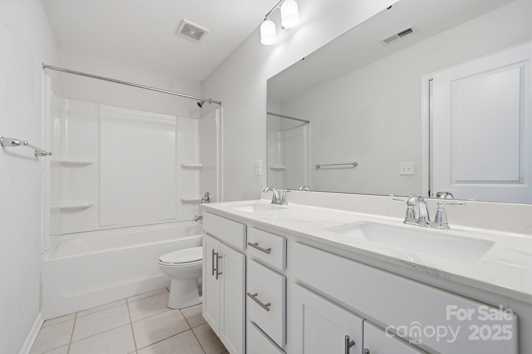 2612 Keady Mill Loop Kannapolis, NC 28081 - Photo 41 of 48 a bathroom with a granite countertop sink a toilet and bathtub