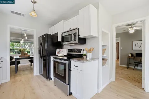 a kitchen with a refrigerator a stove and a sink