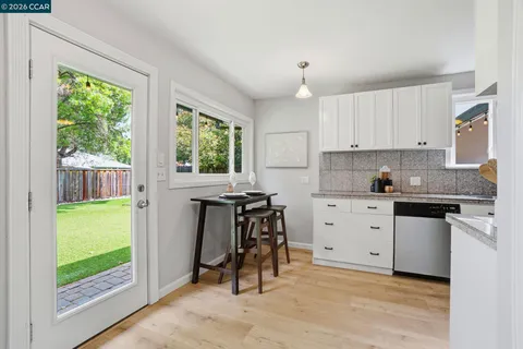 a kitchen with a stove a sink and a refrigerator