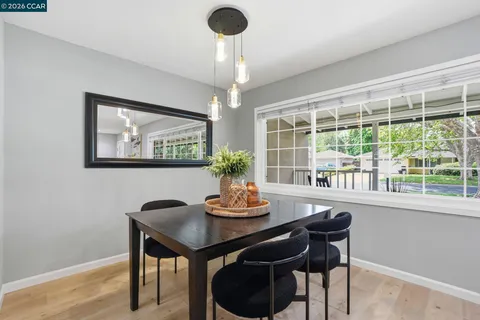 a dining room with furniture and window