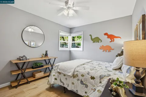 a bedroom with a bed a dresser and chair