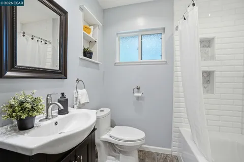 a bathroom with a sink toilet and mirror