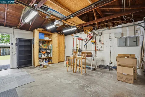 a backyard of a house with table and chairs
