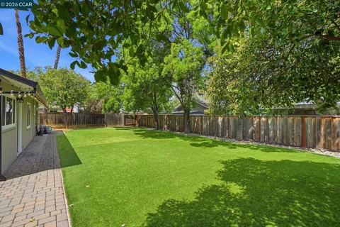 a house view with a sitting space and garden