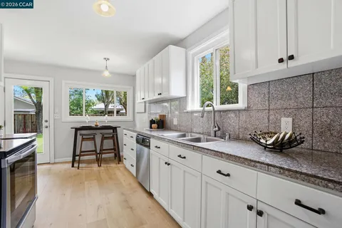 a kitchen with sink a window and appliances