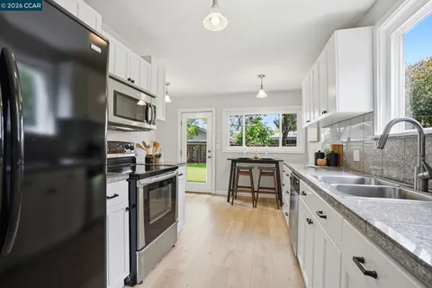 a kitchen with a sink stove and refrigerator
