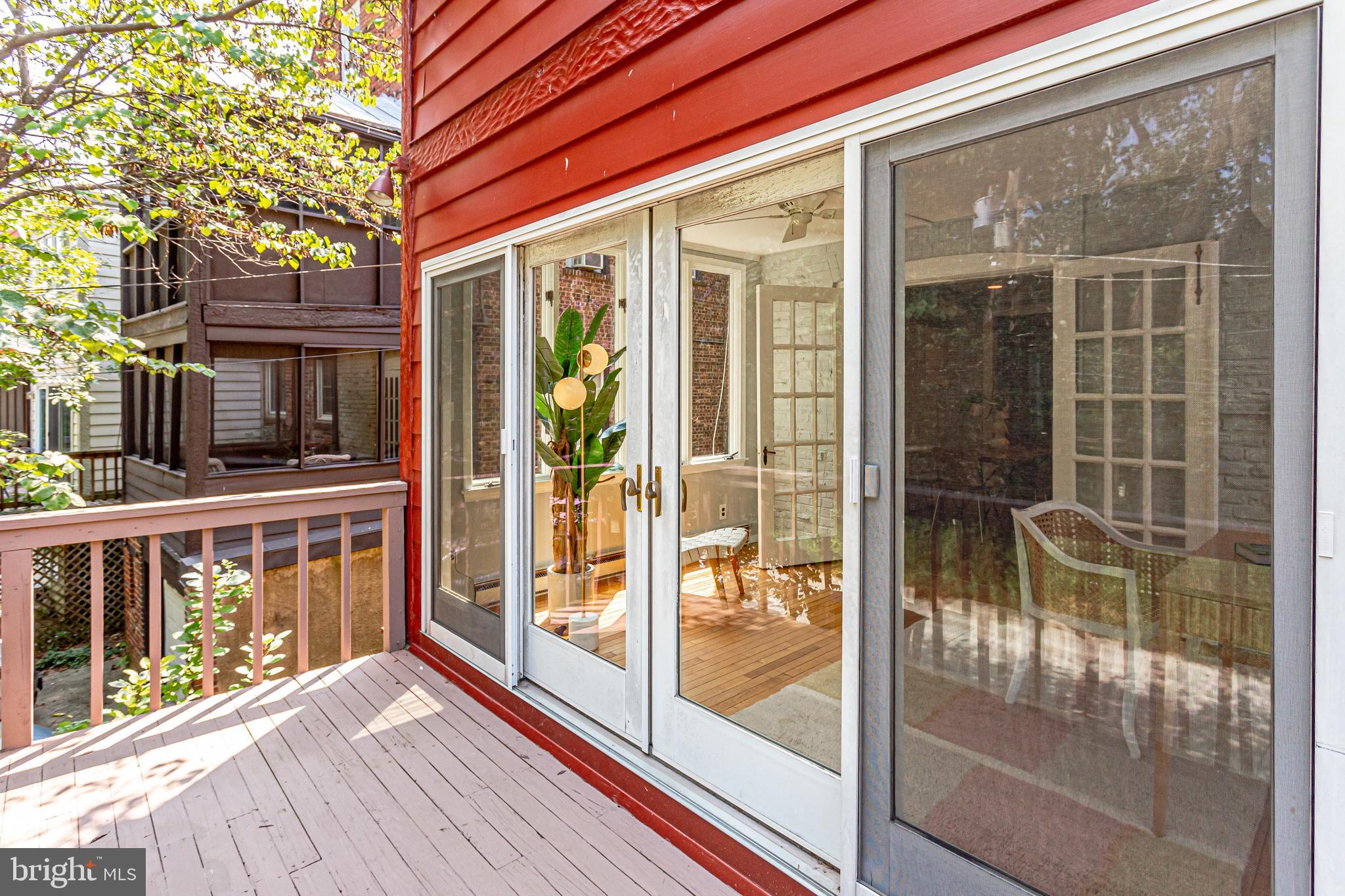 1563 44th Street Northwest Washington, DC 20007 - Photo 42 of 46 Sliders and deck off of sunroom