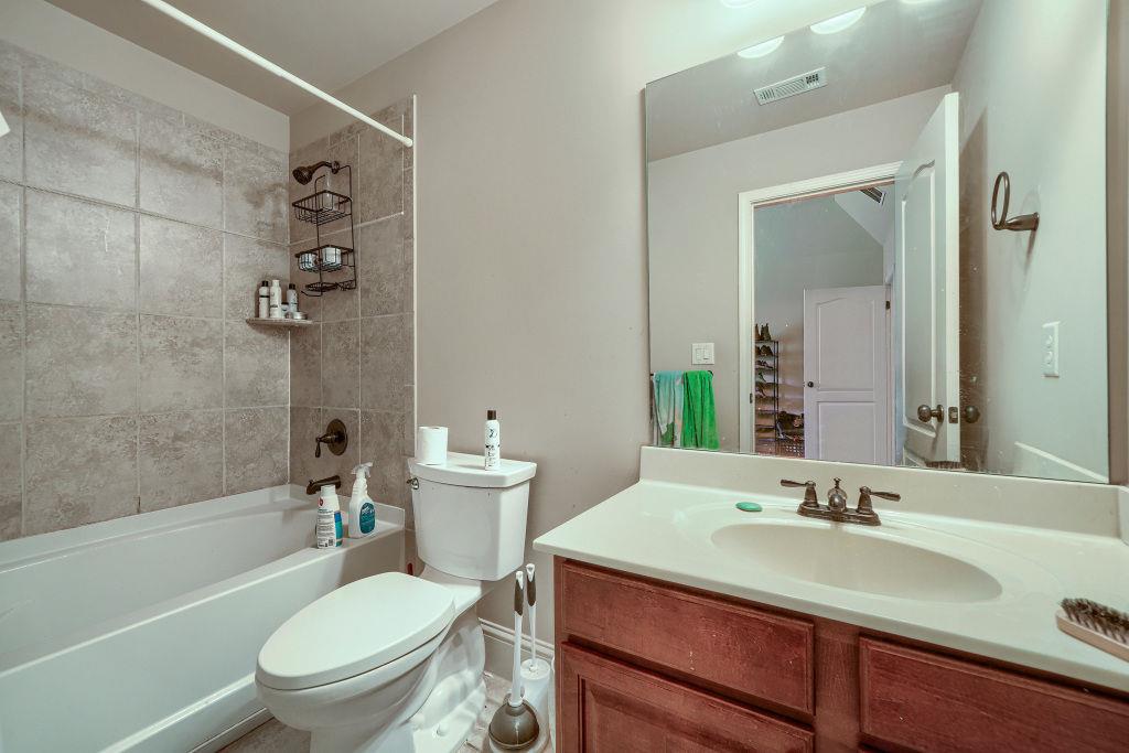 345 Masters Club Boulevard Hampton, GA 30228 - Photo 24 of 30 a bathroom with a sink toilet vanity tub and shower