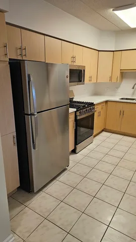 a kitchen with a refrigerator and a stove