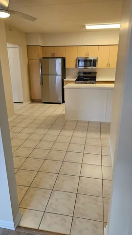 a kitchen with a sink and a refrigerator
