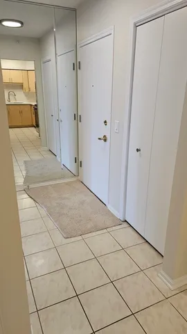 a view of a hallway to rooms