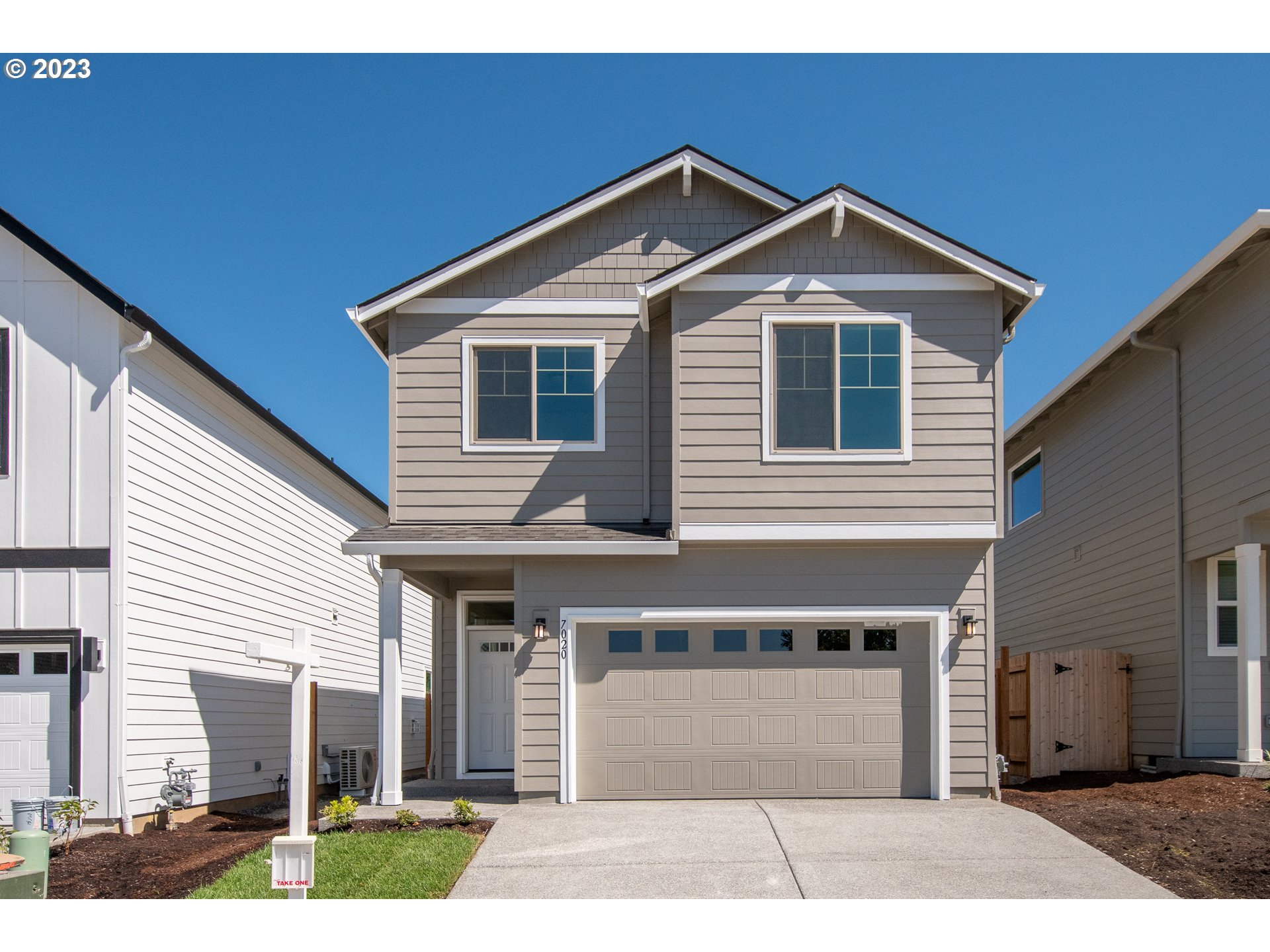 7020 North Madison Circle Ridgefield, WA 98642 - Photo 1 of 1 a front view of a house with a yard and garage