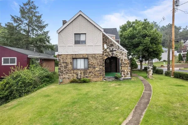 a front view of a house with a yard