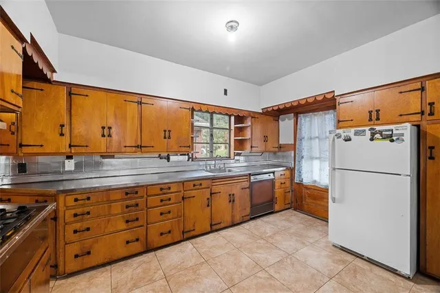 a kitchen with a refrigerator and a sink