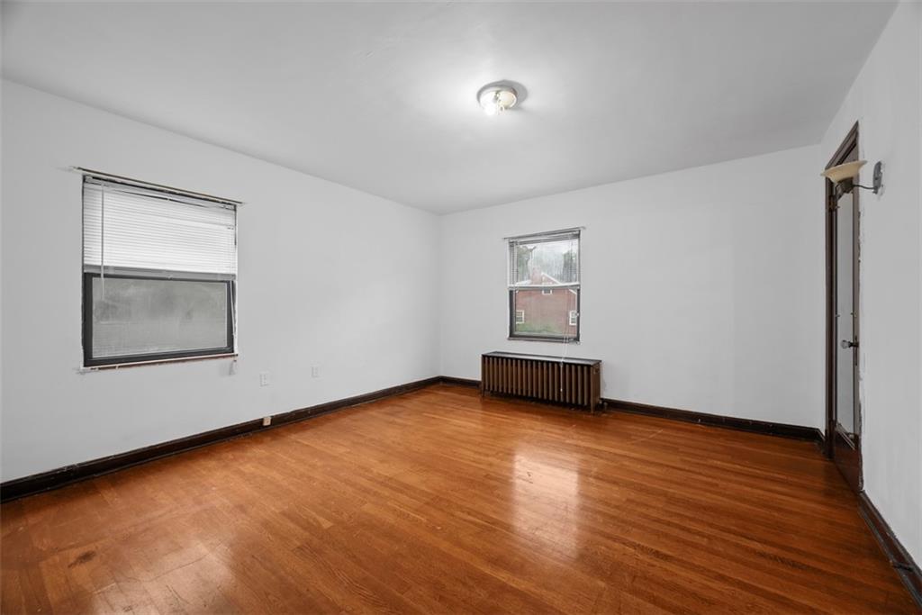 835 Charles Street Carnegie, PA 15106 - Photo 23 of 35 a view of an empty room with wooden floor and a window
