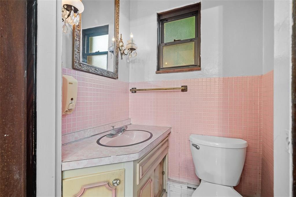 835 Charles Street Carnegie, PA 15106 - Photo 6 of 35 a bathroom with a sink a toilet and mirror