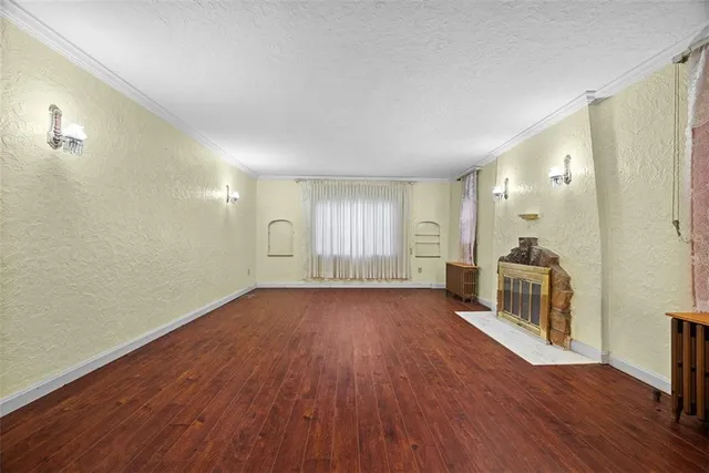 a big room with wooden floor and windows