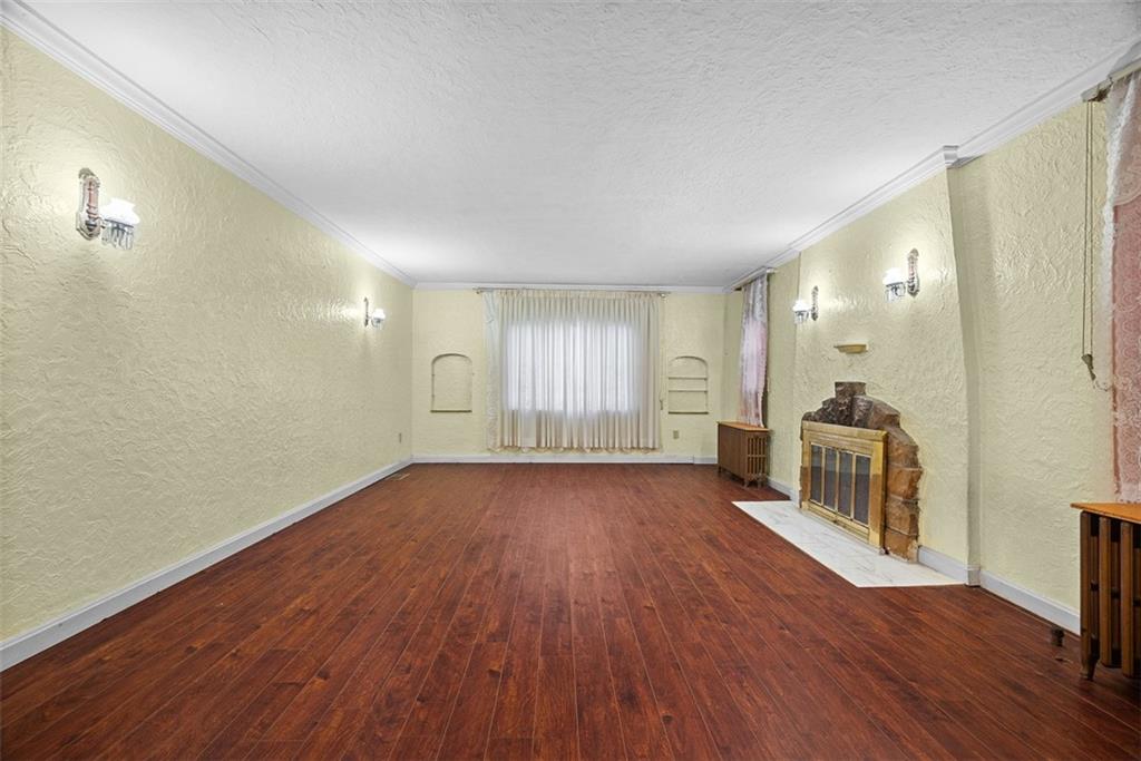 835 Charles Street Carnegie, PA 15106 - Photo 7 of 35 an empty room with wooden floor and windows
