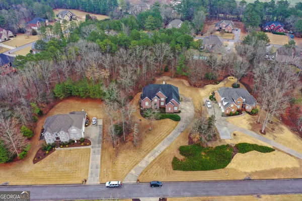 an aerial view of a house with outdoor space
