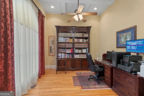 a view of entryway and hall with wooden floor