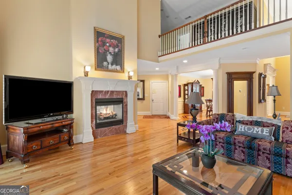 a kitchen with stainless steel appliances wooden floor a stove top oven a sink and a refrigerator