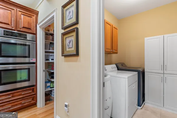 a spacious bedroom with a large bed a fireplace and a chandelier