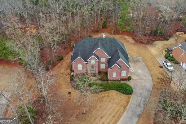 an aerial view of a house with yard swimming pool and outdoor seating