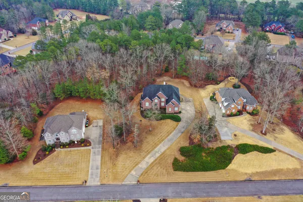 an aerial view of a house with yard swimming pool and outdoor seating