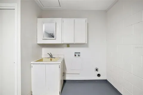 a bathroom with a sink and cabinets