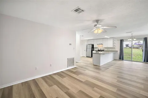 a view of kitchen with wooden floor and window