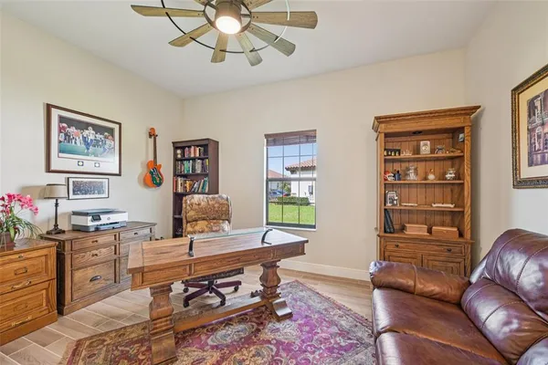a living room with furniture a rug and a window