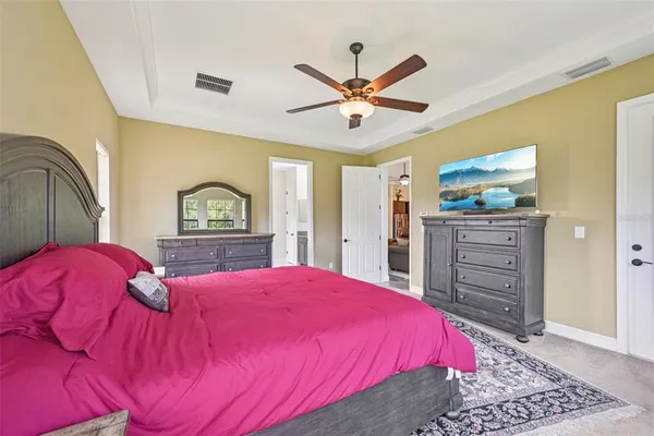 a bedroom with a bed and a painting on the wall